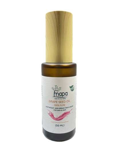 Bottle of Mada Grapeseed Oil with a wooden applicator on a white background
