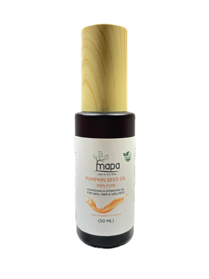 Bottle of pumpkin seed oil with a wooden applicator on a white background