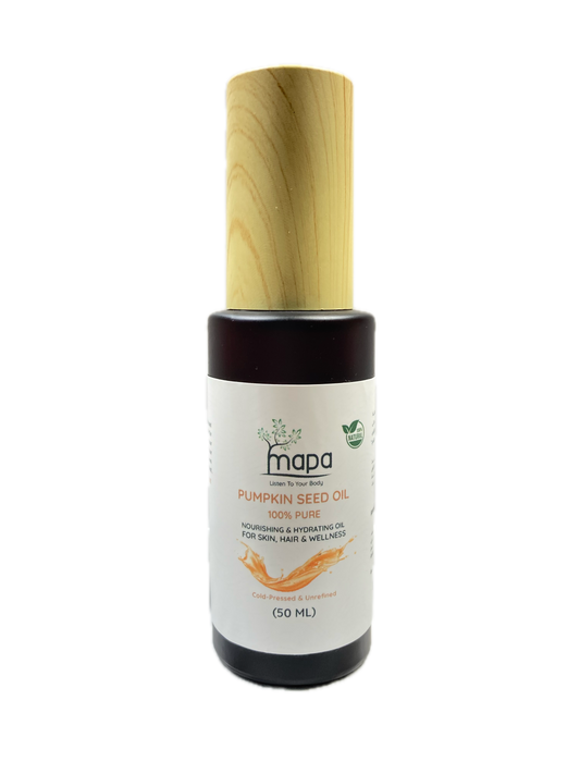 Bottle of pumpkin seed oil with a wooden applicator on a white background